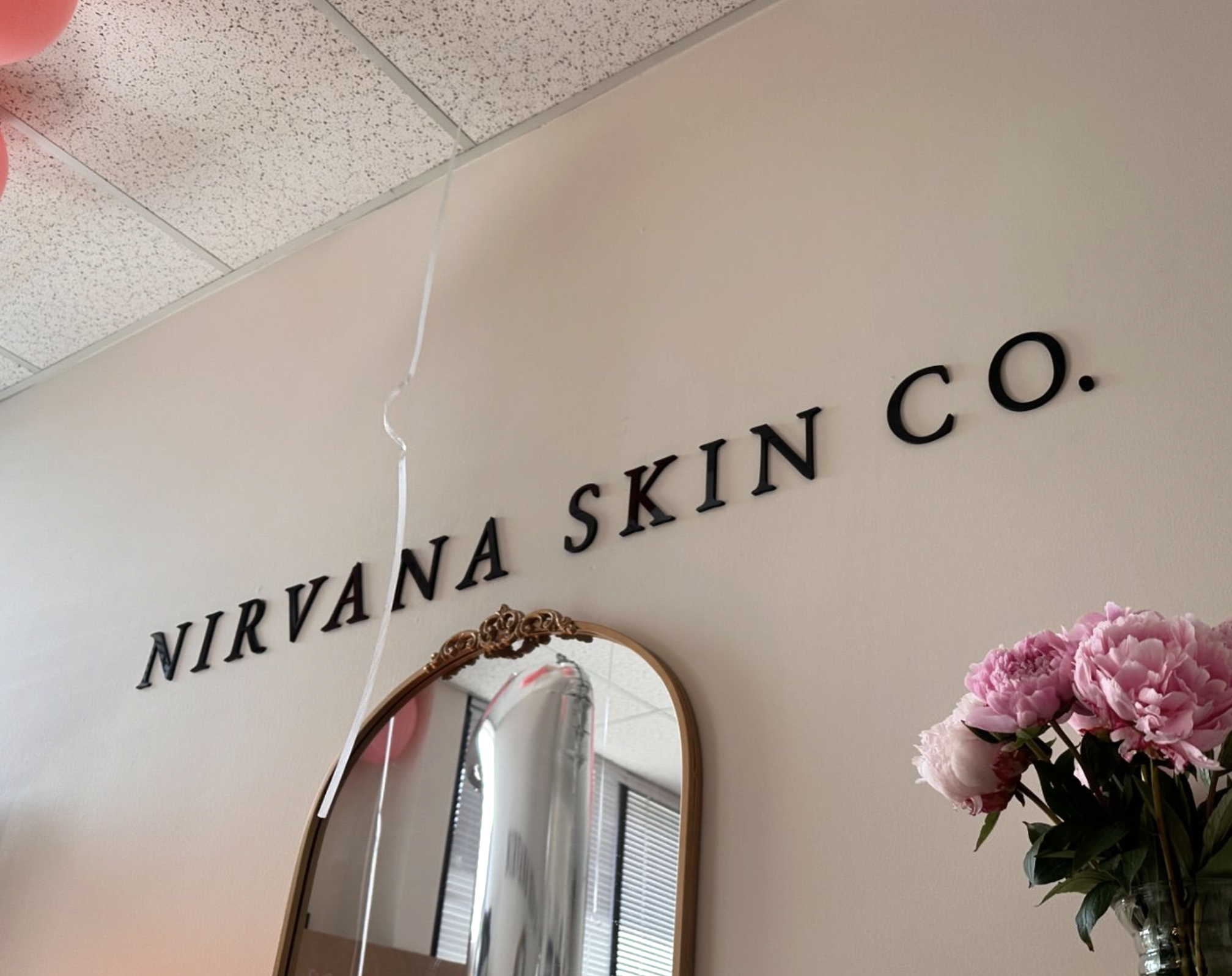 Nirvana Skin Co. sign on the studio wall